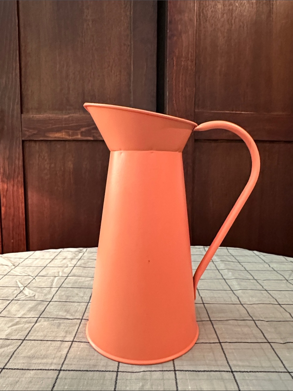 Salmon colored metal pitcher vase